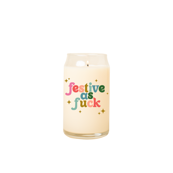 Can glass candle with text that reads "festive as fuck" in multi-color font on the front; text is surrounded by gold minimalist sparkle-stars.