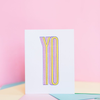 White greeting card with vertically stretched text 