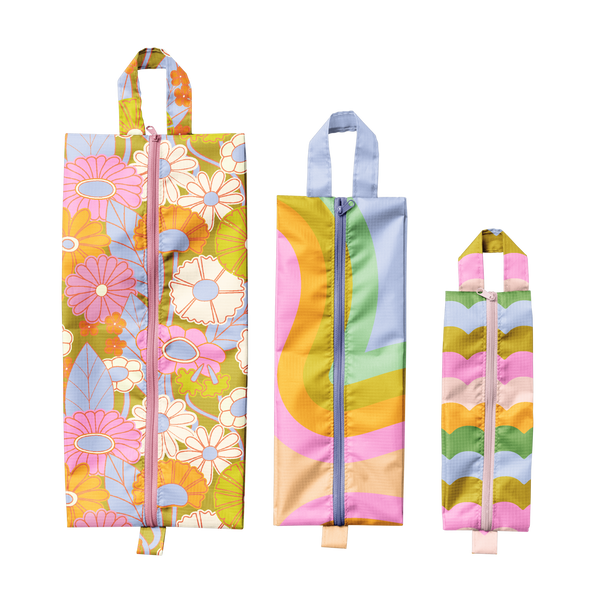 (Left to right) Gathering flowers pattern large pouch, multi color waves medium pouch and multi color rising scallops small pouch.