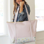 a girl holding a pink vegan leather bag with splatter on the bottom