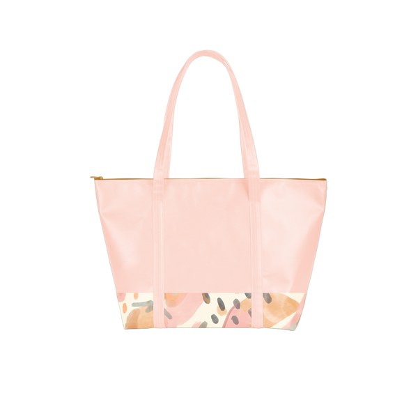 Cute travel bag in peach vegan leather with abstract fruit pattern, zippered top, and double shoulder straps.