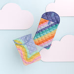 Two foldover laptops floating in the clouds, one rainbow scalloped and the other rainbow waves.
