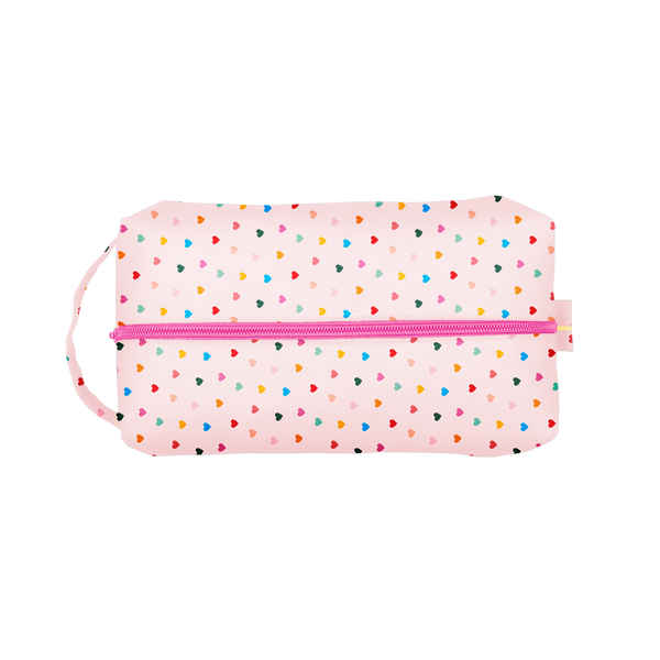 Tiny Hearts Doppelganger is a large travel toiletries case with a carrying handle and rainbow hearts pattern.