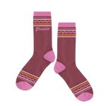 A jewel-toned purple sock with different line designed on the ankle and toe of the sock. "Feminist" is printed under line design.
