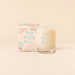 14 oz Rocks glass candle with text that reads "NO WORRIES" in blue font. Box packaging with same design sits behind candle.
