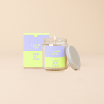 An 8 oz. candle w/ a lid and a split-colored decal (Lilac and Citron) and the phrase , "I like you and my dog" printed on.