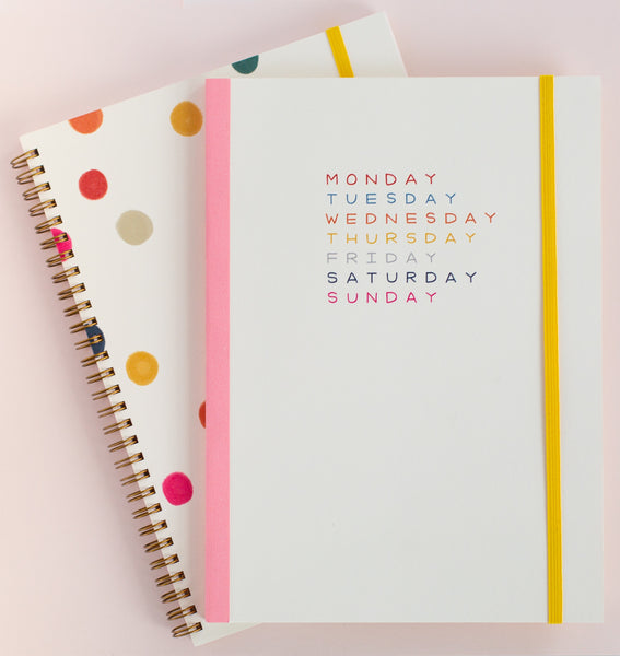 Weekdays planner on top of the ballpit notebook