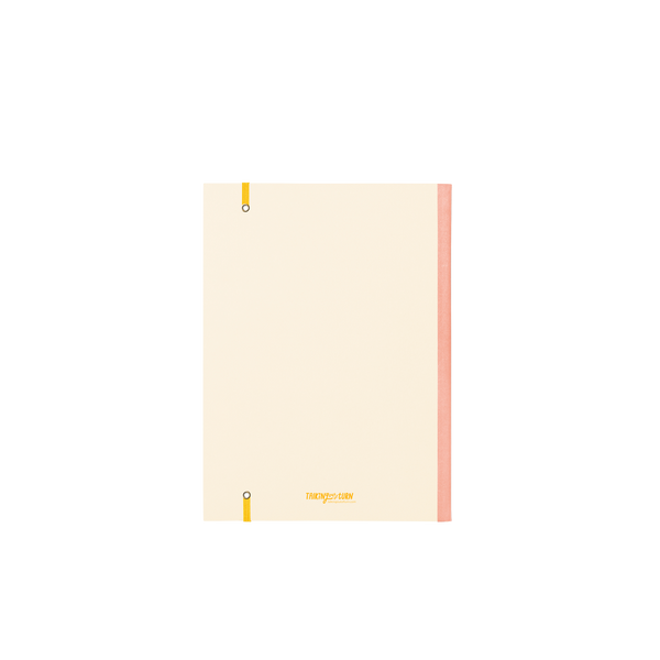 Back cover of a large cream planner with peach binding and yellow elastic closure.