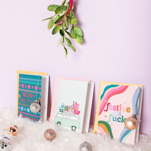 3 different greeting cards under a mistletoe