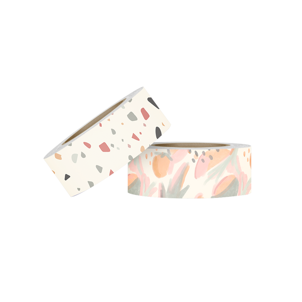 Two rolls of washi tape. The first is white with a  grey, blue, red, yellow and brown terrazzo pattern. The second roll is a watercolored botanical and fruit pattern in light green, corals, orange and pink. 