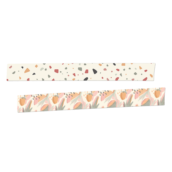 Two rolls of washi tape rolled out.  The first is white with a grey, blue, red, yellow and brown terrazzo pattern. The second roll is a watercolored botanical and fruit pattern in light green, corals, orange and pink.