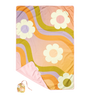 Picnic pal that comes in a small bad and with an ombre background, with white daisies, and a groovy wave pattern in the color of green, purple, and orange. 