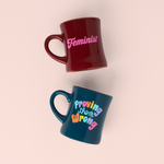 two old school diner mugs- one sangria with feminist in pink and a navy one with colorful letters saying proving them wrong?id=28703047745717
