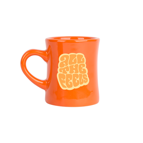 orange old fashioned diner-style mug with saying "all the feels" in lighter orange with yellow shadow