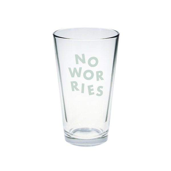 Clear glass pint glass with No Worries printed in powder blue.