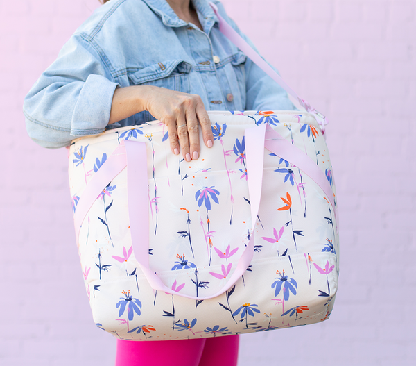 girl carrying a large soft cooler bag with pastel print