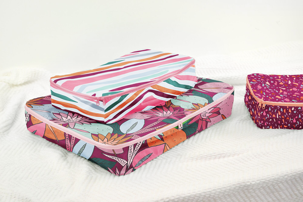 A small, medium, and large packing cube set which folds into a pouch. One with cranberry speckle, one jewel tone stripes, and one floral collage. 