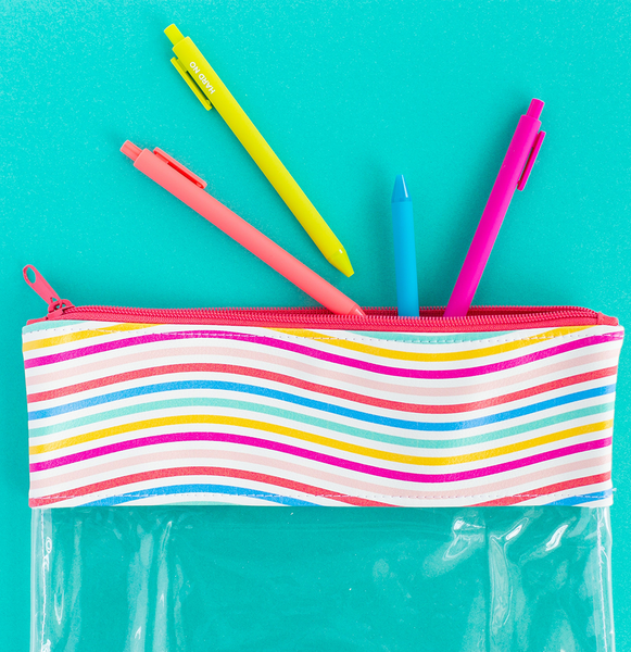 A pouch with clear vinyl and rainbow wavy line vegan leather.  There are bright colored jotter pens hanging out of the pouch. 