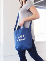 Girl wearing a cute crossbody tote in navy blue canvas with Not Today design..