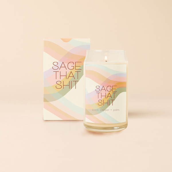 A 16oz. candle with a decal that has multicolored wavy lines and says, "SAGE THAT SHIT." Scent is black pepper & palm.