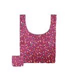 A multicolored, jewel toned Terrazzo speckled tote bag with a magenta background.