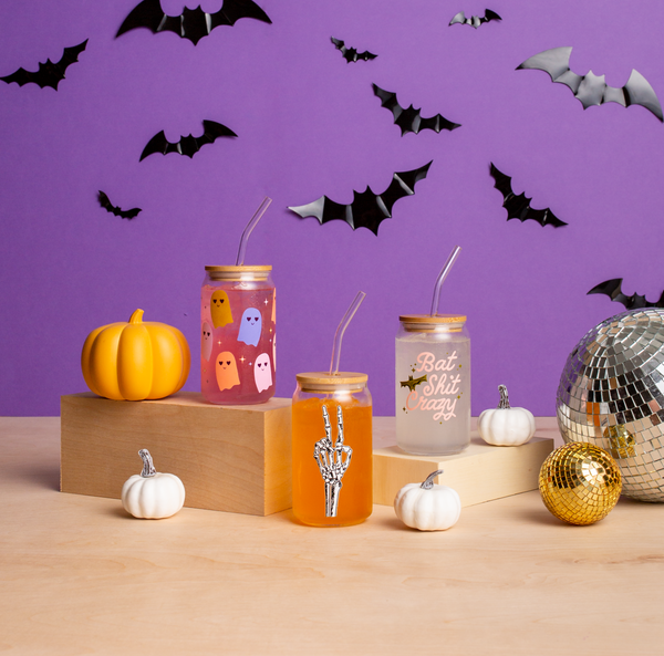 Can Glass with lid in various Halloween designs; Can glass with lid with multi-colored ghosts; Can glass with lid with skeleton peace sign; can glass with lid with bat shit crazy
