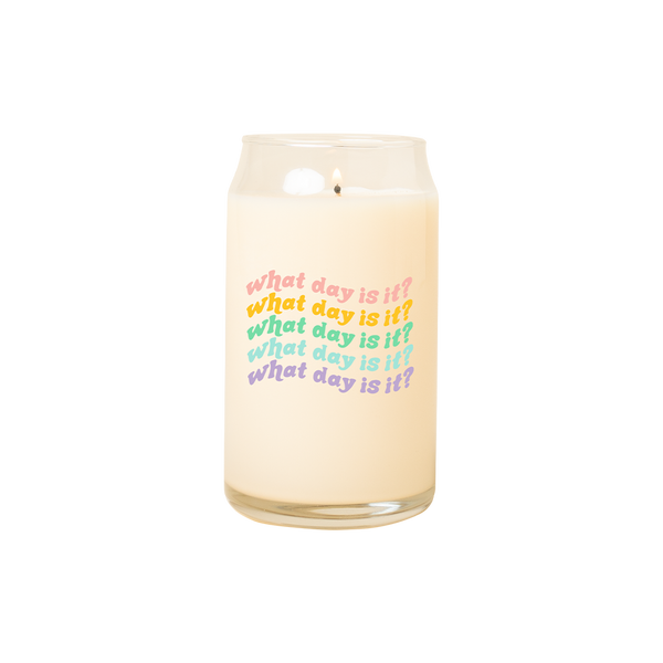 A 16 oz. candle with "What day is it?" printed on multiple times in different colors.