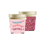 ice cream pint holder in maroon with multi-color pink, green, red, and white confetti design wrapped around. ice cream holder in pink with the phrase making spirits brights being sprung out in lights.