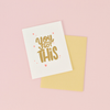 White greeting card with gold text 