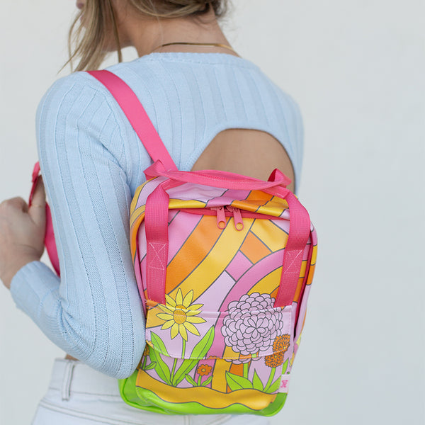 Cute, groovy flower pattern with rainbow swirls printed onto the mini backpack.