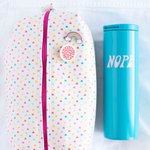 A white, medium-sized pouch with multicolored mini hearts printed all over. Next to the pouch is a bright blue tumbler with the phrase "Nope" printed on in light purple lettering. Both displayed on a white background.