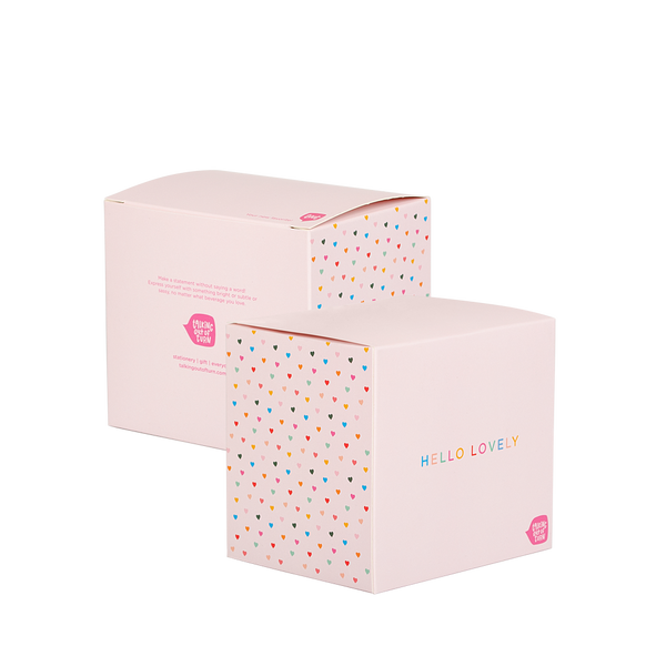 Packaging for the mug that is light pink with rainbow hearts