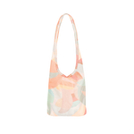 A tote bag with pastel pinks, greens, blues, and reds. Design on bag is multiple moons, overlapping each other. 