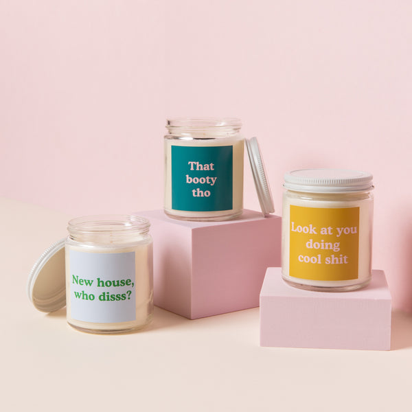 3 candle jars displayed next to each other, from left to right: "New house, who disss?", "That booty tho", and "Look at you doing cool shit".