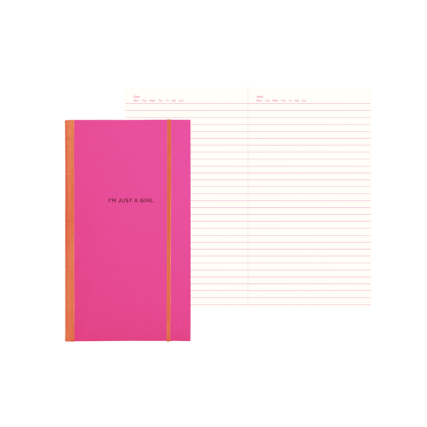 Pink skinny notebook with an orange binder and maroon text with "I'm Just A Girl" on the cover and lined pages.