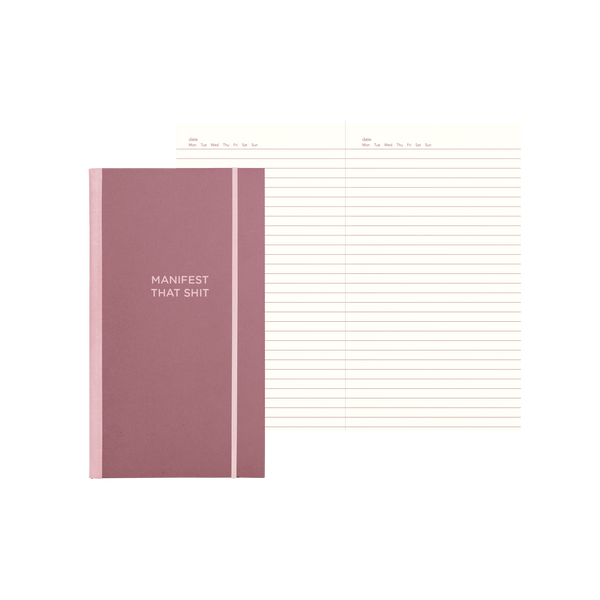 Muave notebook with "Manifest That Shit" on the cover and lines pages.