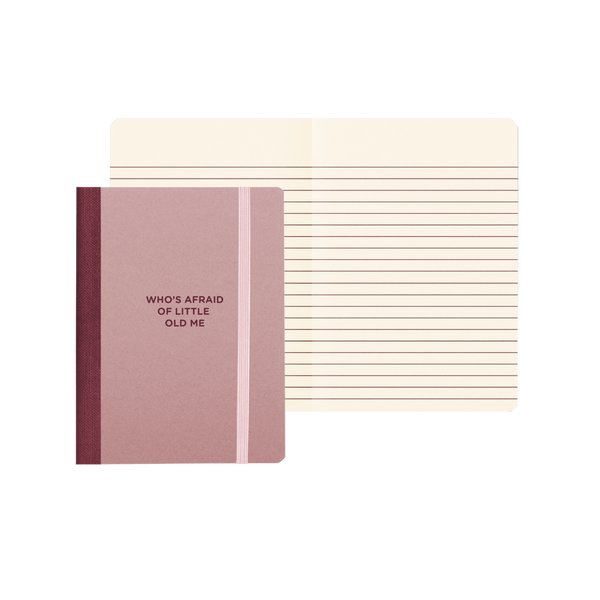 Small mauve notebook with text in maroon with "Who's Afraid Of Little Old Me" on the cover with lined pages.