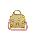 Retro-style bag with a wavy yellow and lavender checkerboard pattern, featuring daisy flower prints in brown and peach tones. Includes pink handles and a matching adjustable shoulder strap—perfect as a skate bag, weekend tote, or playful accessory for vintage and Y2K fashion lovers.