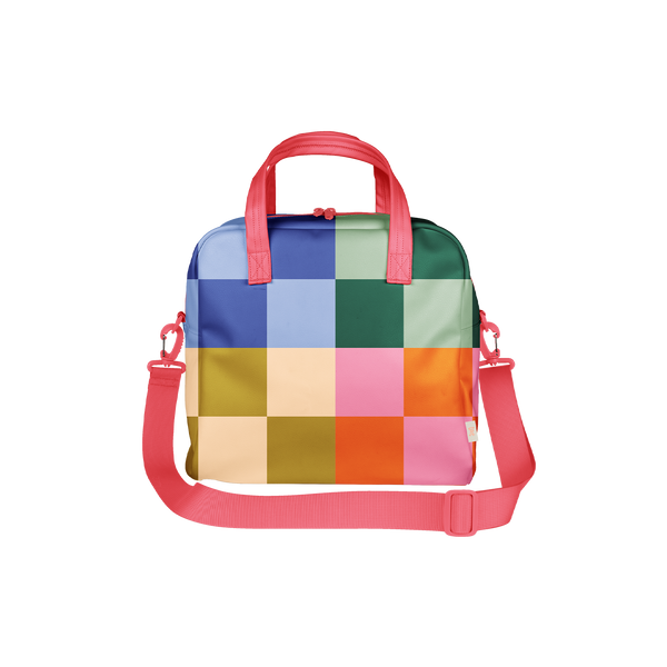 Bold and colorful checkered bag with a grid pattern in vibrant hues of blue, pink, green, orange, yellow, and cream. Features bright coral pink handles and a matching adjustable shoulder strap—perfect for roller skates, gym essentials, or making a fun retro fashion statement.