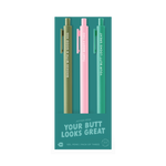 A trio of gel jotter pens on teal packaging labeled “YOUR BUTT LOOKS GREAT.” The olive green pen says “BADASS WITH A GOOD ASS,” the light pink pen reads “THAT BOOTY THO,” and the teal green pen says “YOUR BUTT LOOKS GREAT.” Packaging indicates it’s a gel pen pack of three with ink that matches the barrel color.