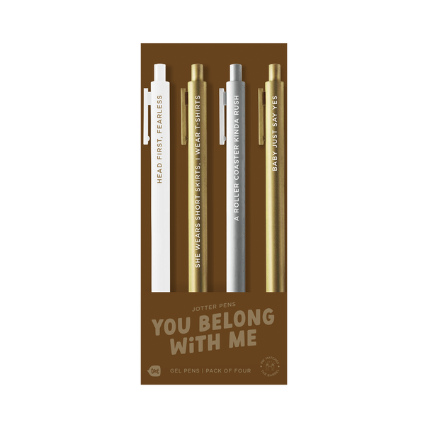 A pack of four gel jotter pens displayed on bronze packaging labeled “YOU BELONG WITH ME.” Each pen features a metallic or neutral tone with Taylor Swift-inspired lyrics:

White pen: “HEAD FIRST, FEARLESS”

Gold pen: “SHE’S CHEER CAPTAIN & I’M ON THE BLEACHERS”

Silver pen: “A ROLLER COASTER KINDA RUSH”

Gold pen: “BABY JUST SAY YES”