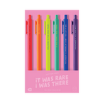 A vibrant 6-pack of gel jotter pens displayed on a pink background labeled “IT WAS RARE, I WAS THERE.” Each pen has a neon or bold-colored barrel with a lyric or reference from Taylor Swift’s Eras Tour:

Red pen: “IT’S BEEN A LONG TIME COMING…”

Orange pen: “OH, HI!!!!!!!!!”

Yellow pen: “WELCOME TO THE ERAS TOUR!”

Teal pen: “IT WAS RARE, I WAS THERE.”

Blue pen: “THIS NIGHT IS SPARKLIN’ DON’T YOU LET IT GO.”

Purple pen: “I REMEMBER IT ALL TOO WELL.”