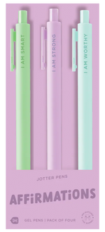 A pack of four pastel jotter pens displayed on lavender packaging. Each pen features a different affirmation: mint green says “I AM SMART,” light purple says “I AM STRONG,” and light aqua says “I AM WORTHY.” The fourth pen is mostly hidden. The bottom of the packaging reads “JOTTER PENS – AFFIRMATIONS – Gel Pens | Pack of Four.”