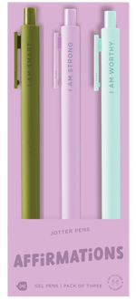 A pack of four pastel jotter pens displayed on lavender packaging. Each pen features a different affirmation: mint green says “I AM SMART,” light purple says “I AM STRONG,” and light aqua says “I AM WORTHY.” The fourth pen is mostly hidden. The bottom of the packaging reads “JOTTER PENS – AFFIRMATIONS – Gel Pens | Pack of Four.”