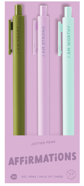 A pack of four pastel jotter pens displayed on lavender packaging. Each pen features a different affirmation: mint green says “I AM SMART,” light purple says “I AM STRONG,” and light aqua says “I AM WORTHY.” The fourth pen is mostly hidden. The bottom of the packaging reads “JOTTER PENS – AFFIRMATIONS – Gel Pens | Pack of Four.”
