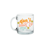 Colorful "dont talk to me" text on a glass mug with smiley faces