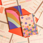 Colorful 2025-2026 Toot academic planners one floral design one with a rainbow wave surrounded by academic planner guts