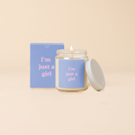 A Yippie Toot Candle Jar with Lid that says I'm just a girl in pink on a blue background with a matching box 