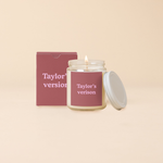 A Yippie Toot Candle Jar with Lid that says Taylor's version in pink on a vintage wine like background with a matching box. 