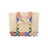 A neutral colored canvas tote bag with a bold colorful checkered print along the bottom of the bag and straps. The saying 